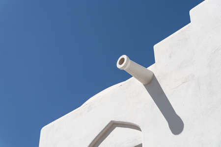 White building with a pipe on the blu sky backgroundの写真素材