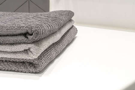 Gray towels on the table in the bathroom. Background for hotel serviceの写真素材