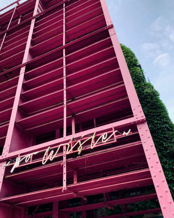 Pink construction in the street with neon sign