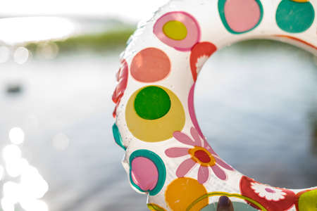Rubber duck on the beach, lifesaver ring on the sea