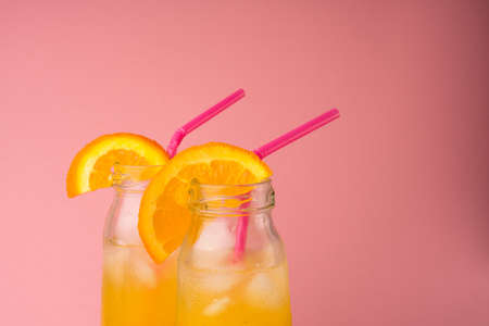 Fresh tropical mango juice with beautiful diced pulp and striped paper strawの写真素材