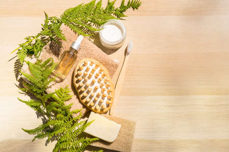 Zero waste bathroom accessories flat lay wooden desk background, spa body care concept. Natural sisal body brushes for dry anti-cellulite massage, black bamboo toothbrushes. Eco-friendly lifestyle.の写真素材