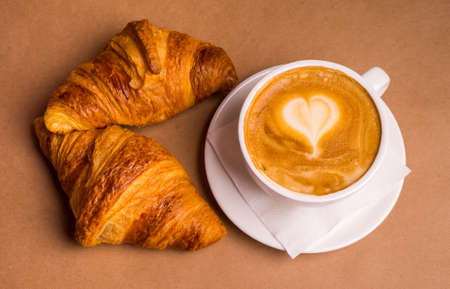 Top view of tasty breakfast with cereal flakes and croissants with coffeeの写真素材