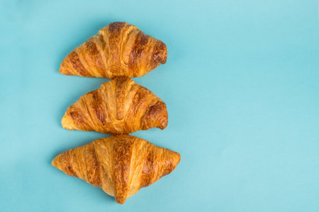 Top view of tasty breakfast with cereal flakes and croissants with coffee