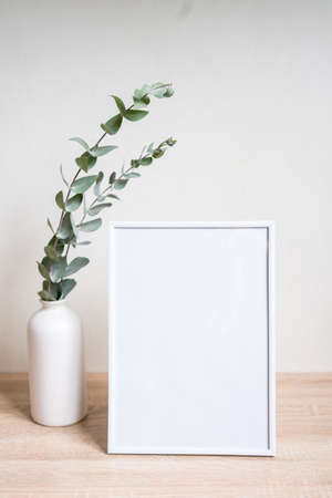 Minimalist home decor with empty frame mock-up on white wall background
