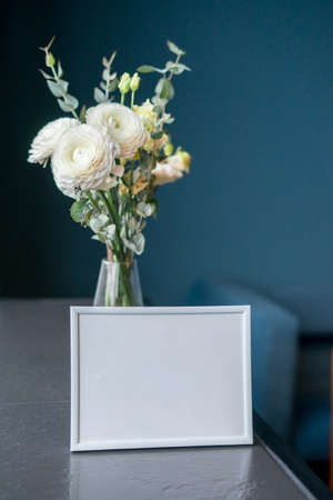 Beautiful ranunculus flowers on blue background with frame mock up