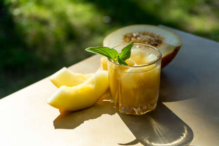The juice of melon with mint in a glass jar on the table.Hami melonの写真素材