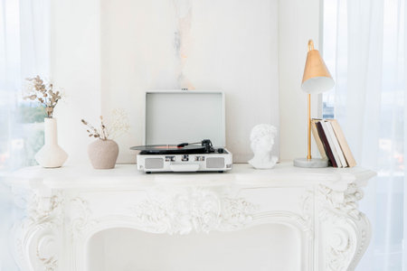 Record player with vinyl disc on table in roomの写真素材
