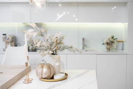 Christmas decor. Bright interior of white kitchen with decorated Christmas tree, garlands and Christmas wreaths.の写真素材