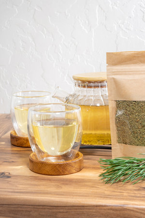 Pine needles tea in white cup. Healthy winter beverage in camping, pine tree needles tea in mug.の写真素材
