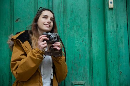 Photo of young tourist girl exploring streets of Baku. Moody photos of teenager girl visiting old city and taking photos of the city.の写真素材