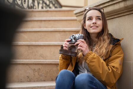 Photo of young tourist girl exploring streets of Baku. Moody photos of teenager girl visiting old city and taking photos of the city.の写真素材