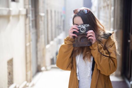 Photo of young tourist girl exploring streets of Baku. Moody photos of teenager girl visiting old city and taking photos of the city.の写真素材