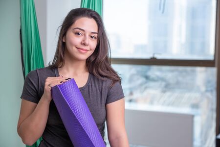 Portrait of young yoga woman yoga trainer indoor. Beautiful girl practice yoga in class. Yoga studio...
