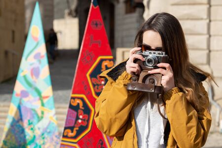 Photo of young tourist girl exploring streets of Baku. Moody photos of teenager girl visiting old city and taking photos of the city.の写真素材