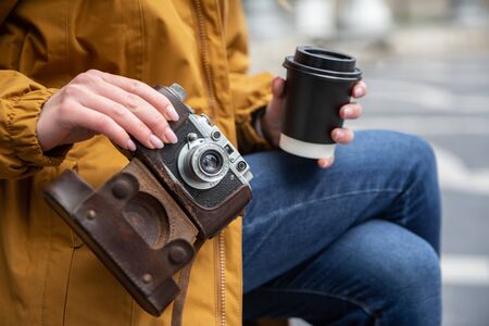 Photo of young tourist girl drinking coffee on streets of Baku. Moody photos of teenager girl...