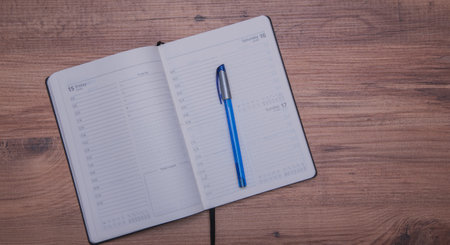 Open notebook and pen on wooden background.Flat lay .Top viewの写真素材