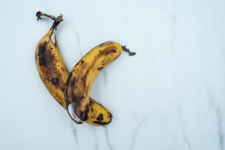 black rotten bananas, rotten bananas on a white background. unhealthy conceptの写真素材