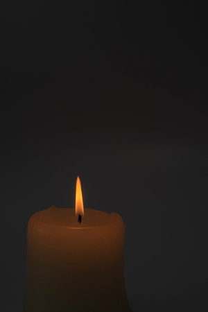 Burning candle on a black background.Copy space.の写真素材