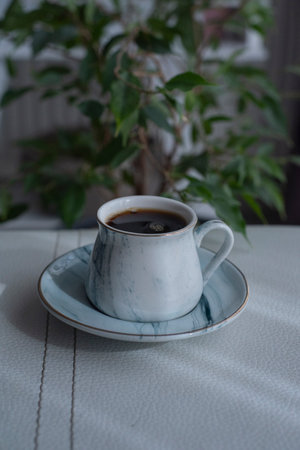 A cup of coffee on white surface.Close-up of hot coffee cup.Hot Coffee Drink Concept