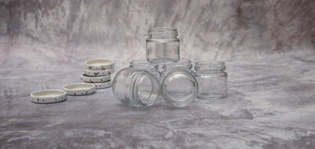 Small glass jars for sauce, jam on gray background. space for your textの写真素材