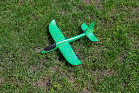 green toy airplane on the lawn.summer concept