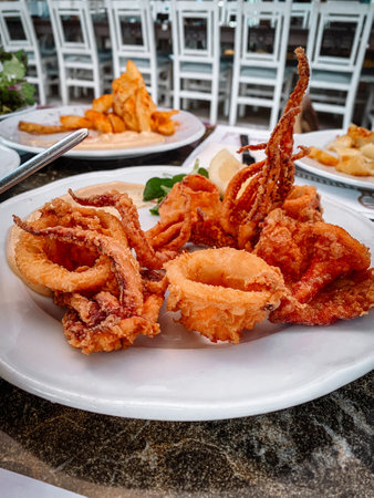 Delicious fried octopus on the white plate.