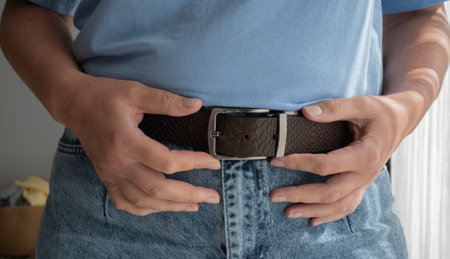 Leather belt on blue jeans