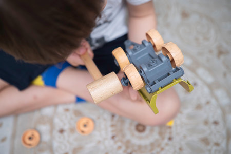 Child with autism playing with cars. Autism concept.