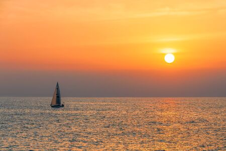 View of a sailing yacht on the background of a golden sunset from Venice fishing pier. California....