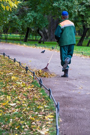Autumn in the park, cleaning leaves
