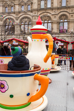 Moscow, Russia, March 7, 2015. Attraction cups of tea spinning in a circle.のeditorial素材