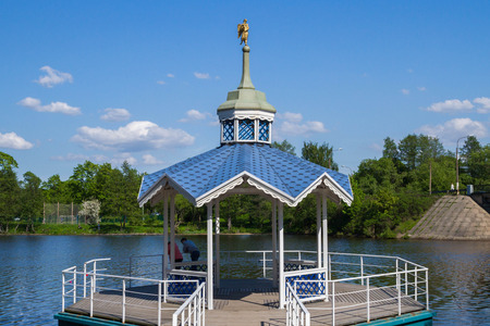 Carved wooden gazebo by the riverの写真素材
