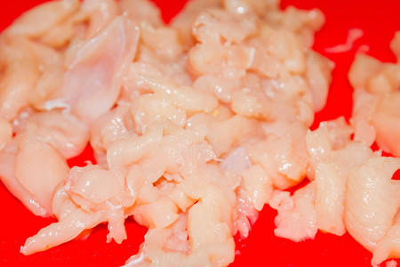 Sliced raw pieces of chicken for the fillingの写真素材