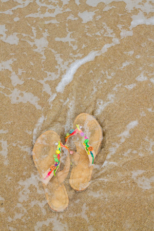 Summer flip flops on the beachの写真素材
