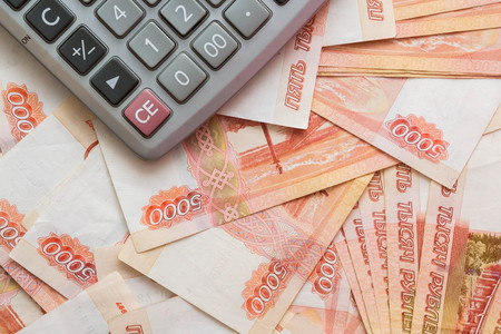 The calculator lies on big Russian moneyの写真素材