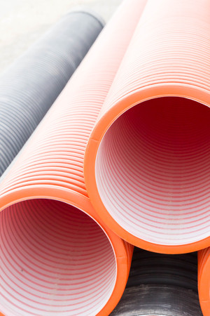 Construction orange and black plastic pipesの写真素材