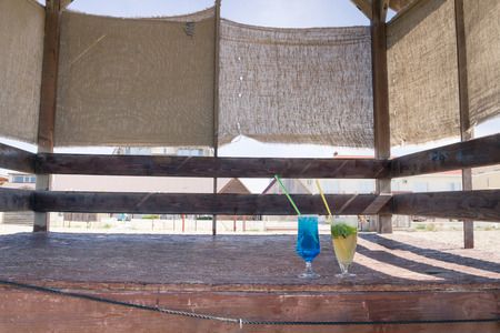 Colourful cocktails with ice on the beach in the hot summerの写真素材