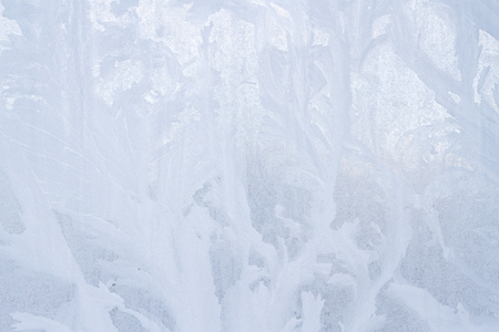 Winter frosty patterns on the frozen ice windowの写真素材