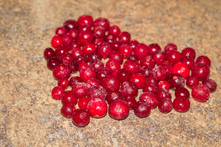 Cold frozen red berry cranberries on the tableの写真素材