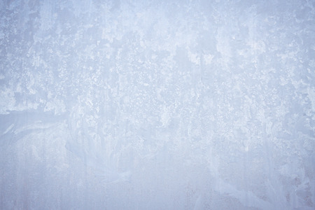 Winter frosty patterns on the frozen ice windowの写真素材