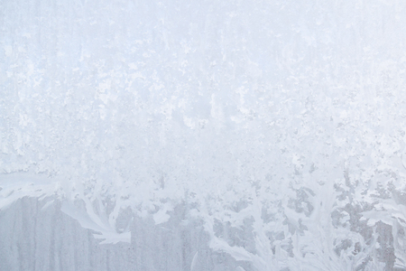 Winter frosty patterns on the frozen ice windowの写真素材