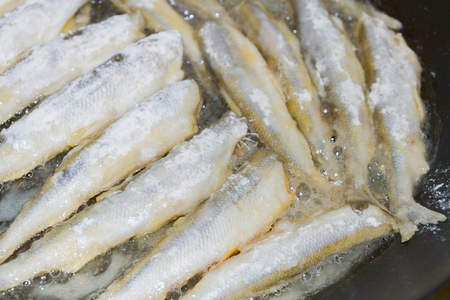 Cooking fried fish smelt rolled in flourの写真素材