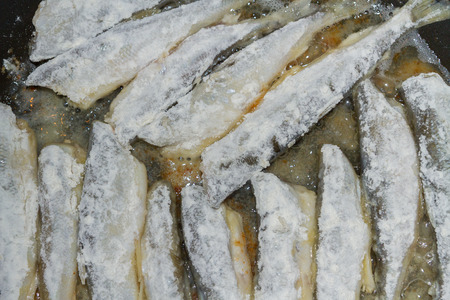 Cooking fried fish smelt rolled in flourの写真素材