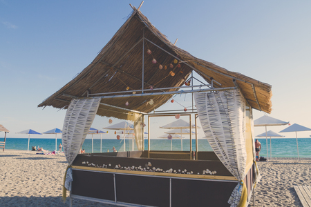 Wooden beach house decorated with sea shells on the beachの写真素材