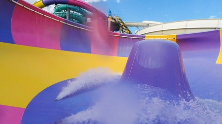 Water color attraction slide with water splashes in an outdoor water Park