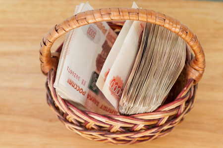 A lot of Russian money in denominations of five thousand rubles are in the basketの写真素材