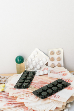 Pills and drugs with large Russian money lie on the tableの写真素材