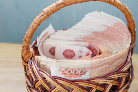 A lot of Russian money in denominations of five thousand rubles are in the basketの写真素材