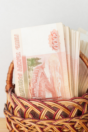 A lot of Russian money in denominations of five thousand rubles are in the basketの写真素材